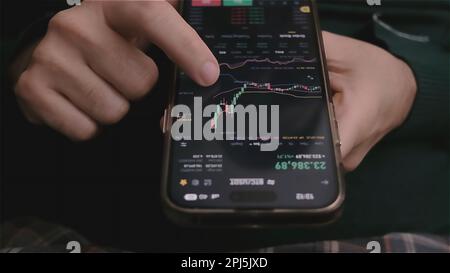 online investor checking Bitcoin, Ethereum cryptocurrency trends on mobile phone, price analyze  Stock Photo