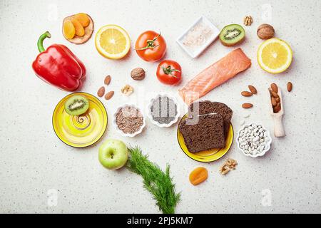 Healthy FODMAP diet food in shape of heart. Organic fruits, vegetables, greenery, nuts, beans, flax seeds, chia seeds, dry fruits, whole grain bread Stock Photo