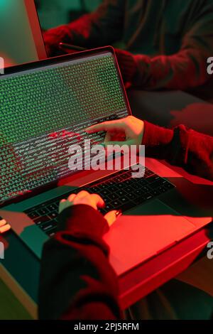 Anonymous people using computer and programming to break code. Cyber security threat. Internet and network security. Access to private information. An Stock Photo