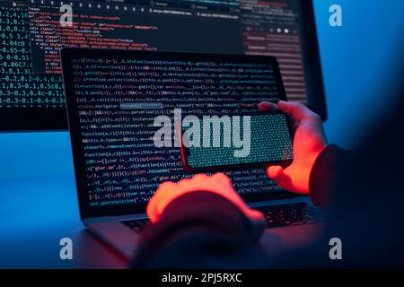 Man using computer and programming  to break code. Cyber security threat. Internet and network security. Stealing private information. Person using te Stock Photo