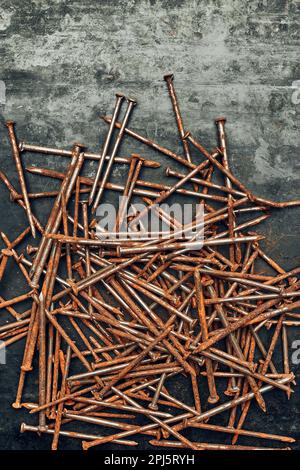 Rusty nails on steel surface. Tools for maintenance. Hardware tools to fix. Technical background with copy space Stock Photo