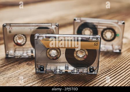 Tape cassettes. Magnetic cassette tapes on wooden table. Retro music style. 80s music party. Vintage style. Analog equipment. Stereo sound Stock Photo