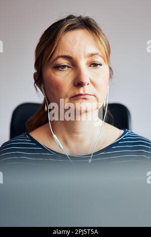 Woman working doing her job remotely during video chat call stream online course webinar on laptop from home during COVID-19 quarantine. Woman sitting Stock Photo