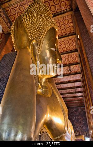 The golden reclining Buddha figure at Wat Pho temple in Bangok, Thailand. Stock Photo