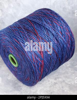 Handmade knitting pattern. Knitted fabric from a multi-colored thread and a large bobbin.Copy space Stock Photo
