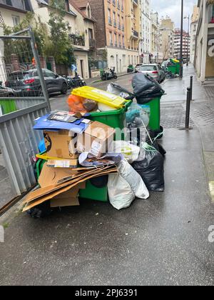 Paris, France. March 21. 2023. Garbage cans piling up in the street due to the garbage collectors' strike. Heap of garbage in the city. Stock Photo