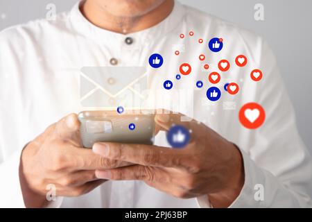Businessmen interact with friends on social media with social media icons. Social media and digital technology concept Stock Photo