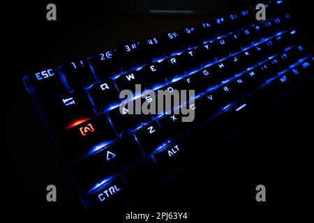 Illuminated RGB gaming backlit keyboard with Red Caps Lock Button Stock Photo