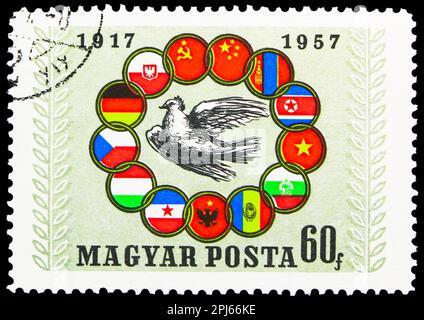 MOSCOW, RUSSIA - MARCH 25, 2023: Postage stamp printed in Hungary shows Peace dove surround by flags of socialist countries, 40th Anniversary of Russi Stock Photo