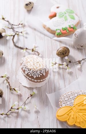 Easter decoration with homemade Easter gingerbread cookies on wooden table Stock Photo