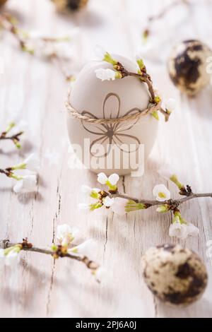 Easter eggs on with cherry branch. Easter decoration with quails eggs Stock Photo