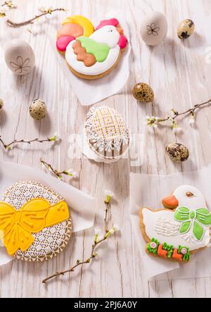 Easter decoration with homemade Easter gingerbread cookies on wooden table Stock Photo