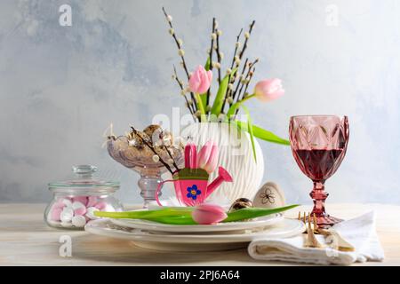 Place setting for Easter table with spring flowers. Easter table decoration Stock Photo
