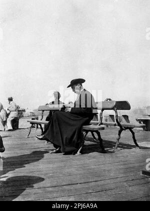 Catholic priest wearing cassock and Saturno hat reading book bible in Calais, France 1895 French priest clergy father Francais Europe European 19th century Stock Photo