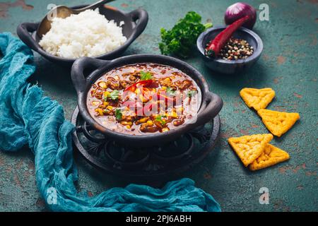 Hot Mexican Chili con carne with rice and tortilla chips and spices Stock Photo