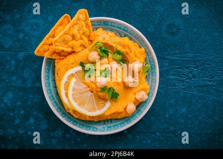 Homemade spicy humus chilli and chickpeas tortilla chips Stock Photo