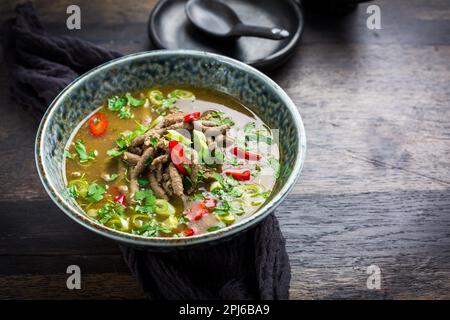 German liver dumpling soup with onion and vegetable on dark background Stock Photo