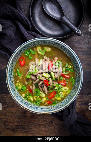 German liver dumpling soup with onion and vegetable on dark background Stock Photo