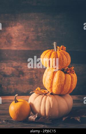 Happy thanksgiving - still life with different pumpkins and autumn leaves on wooden background Stock Photo