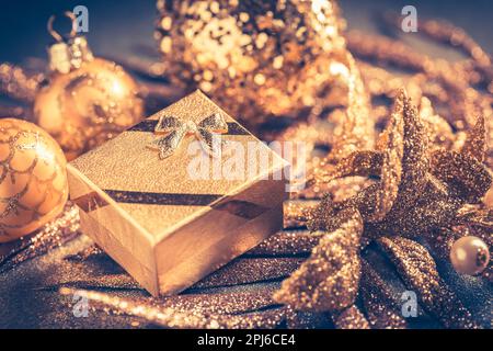 Christmas ornaments with small present in golden tones Stock Photo