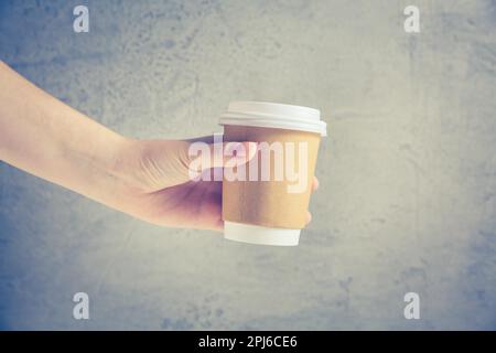 Hand holding disposable coffee cup Stock Photo