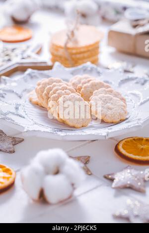 Christmas cookies with orange slices, ornaments on white background Stock Photo