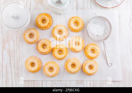 Small sponge cakes with cottage cheese. Ring cakes on white background Stock Photo