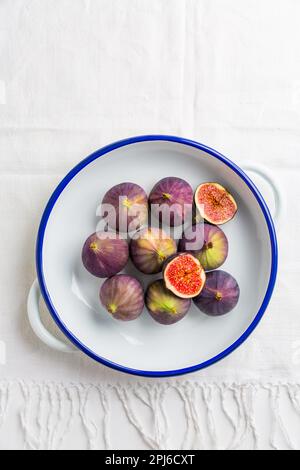Organic fresh figs in bowl on white kitche tableorganic Stock Photo