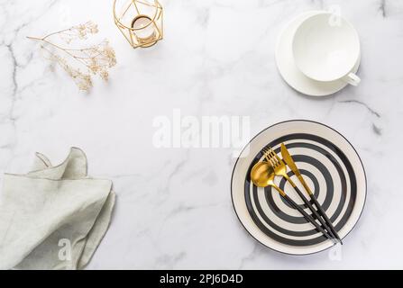 Image of cutlery sets with plate, cup and candle. Party theme, place and table setting Stock Photo