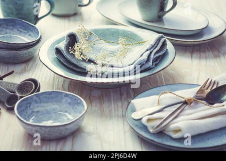 Stoneware kitchen utensils - sustainability. Assortment of plates, bowls and cups from natural materials Stock Photo