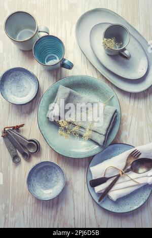 Stoneware kitchen utensils - sustainability. Assortment of plates, bowls and cups from natural materials Stock Photo