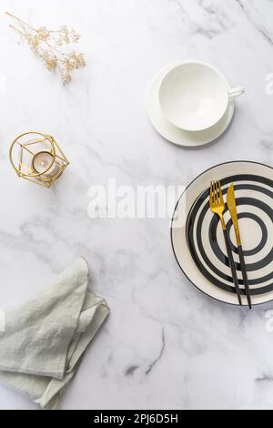 Image of cutlery sets with plate, cup and candle. Party theme, place and table setting Stock Photo