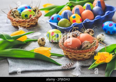Spring time - Easter eggs and tulips on grey background Stock Photo
