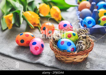 Spring time - Easter eggs and tulips on grey background Stock Photo
