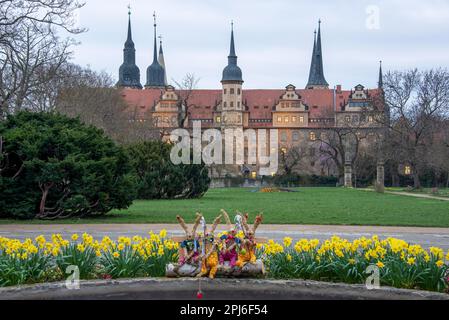 Merseburg Castle, in the foreground four Easter bunnies made of straw, Merseburg, Saxony-Anhalt, Germany Stock Photo