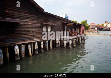 Georgetown, Penang, Malaysia - September 03, 2014: Old wooden  house on stilts in Chew Jetty sea floating village in historical Georgetown,  Malaysia Stock Photo