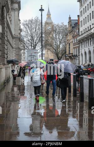 London, UK. 31st Mar, 2023. Londoners and tourists get their umbrellas out whilst walking around the Westminster sights in central London, on a day that has mostly been grey and very rainy in the capital. Credit: Imageplotter/Alamy Live News Stock Photo