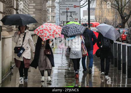 London, UK. 31st Mar, 2023. Londoners and tourists get their umbrellas out whilst walking around the Westminster sights in central London, on a day that has mostly been grey and very rainy in the capital. Credit: Imageplotter/Alamy Live News Stock Photo