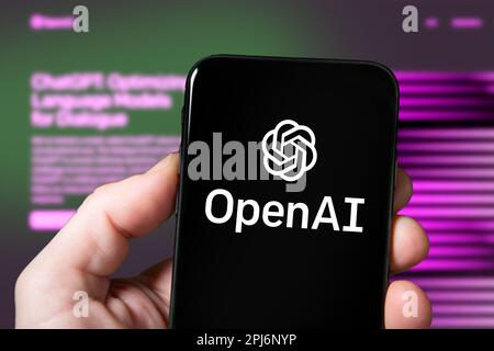 Screen of a smartphone with OpenAI company logo, ChatGPT, AI tool, artificial intelligence. Man using OpenAI website on a mobile Stock Photo