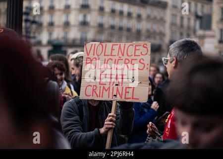 Paris, France. 30th Mar, 2023. A protester holds a placard that says 'Violences policieres État criminel' during the demonstration. Nearly 90 rallies were organized in the country's major cities, in front of the prefectures and town halls against police violence. In Paris thousands gathered in front of Hotel de Ville to demand the resignation of Interior Minister, Gerald Darmanin. After the protest wild demonstrations took place in various parts of the city. Credit: SOPA Images Limited/Alamy Live News Stock Photo