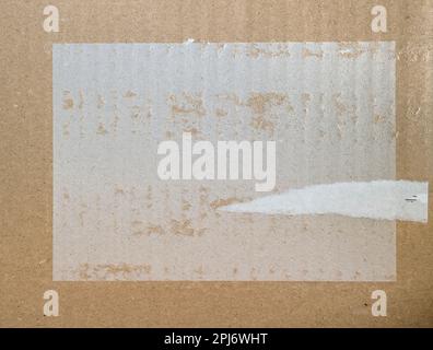 Corrugated cardboard box surface with torn paper scraps and empty copy space Stock Photo