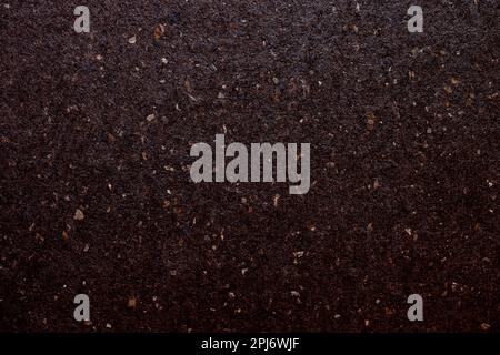 Dark brown colored artisan paper, luxury paper with natural fibres, recycled fine paper background Stock Photo