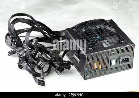 Modern power supply unit, PSU for PC computer or workstation isolated on reflection surface. Stock Photo