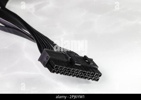 PSU cable, 24 pins connector of the power supply unit to the computer motherboard, 24 Pins ATX standard, 20+4 on reflection surface. Stock Photo