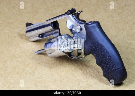 The compact revolver gun, stainless steel j-frame m60 pistol back left side view, open cylinder for refill ammunition. Stock Photo