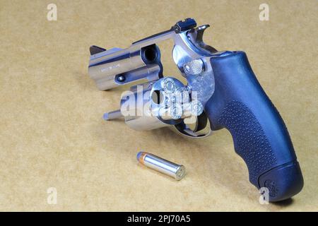 The compact revolver gun, stainless steel j-frame m60 pistol back left side view, open cylinder for refill ammunition. Stock Photo