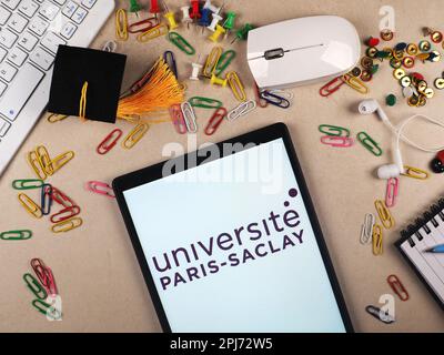 In this photo illustration,  Universit Paris-Saclay  logo seen displayed on a tablet. Stock Photo