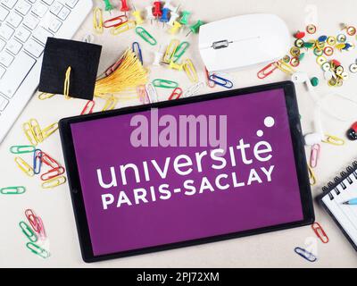 In this photo illustration,  Universit Paris-Saclay  logo seen displayed on a tablet. Stock Photo