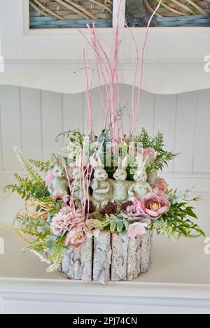 Artificial flower arrangements on white furniture Stock Photo