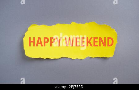 Happy Weekend text written on yellow torn papper, Business concept,gray background. Stock Photo